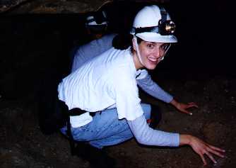 Suhad crouching in a low passageway.